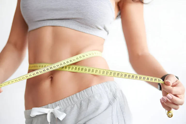 Woman measuring waist with tape—weight loss by ClickSlim.