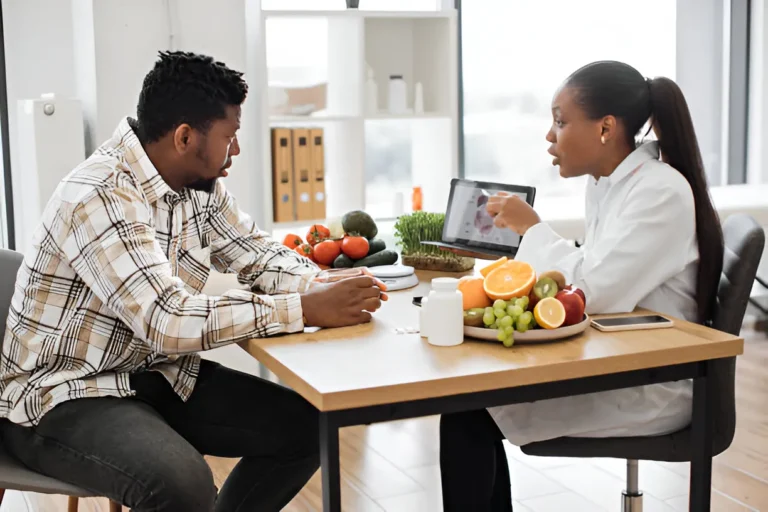 Doctor consulting patient about weight loss using digestive system diagram and dietary supplements on table.