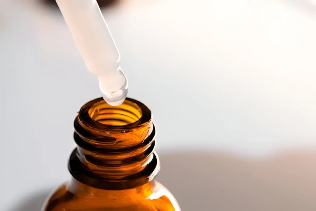 Close-up of oral tirzepatide liquid drops being dispensed from a dropper bottle